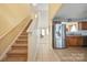 Carpeted staircase leading to the upper level adjacent to the kitchen, offering a view of the living room at 1219 Catawba Run Rd, Lowell, NC 28098