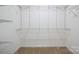 Organized walk-in closet with adjustable shelving units and neutral carpeting at 1219 Catawba Run Rd, Lowell, NC 28098