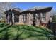 Spacious backyard featuring a screened porch, brick exterior, and lush green lawn at 13008 Ginovanni Way, Mint Hill, NC 28227