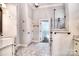 Bathroom featuring neutral tile, a glass shower door, granite countertops and bronze fixtures at 13008 Ginovanni Way, Mint Hill, NC 28227