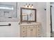 Bathroom featuring granite countertops, cream colored cabinets, bronze fixtures and a decorative mirror at 13008 Ginovanni Way, Mint Hill, NC 28227