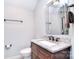 Bathroom vanity featuring granite countertop, sink, bronze fixtures, and decorative mirror at 13008 Ginovanni Way, Mint Hill, NC 28227