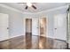 Open bedroom with hardwood floors and multiple doors leading to other rooms at 13008 Ginovanni Way, Mint Hill, NC 28227