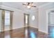 Spacious bedroom featuring hardwood floors, a ceiling fan, and windows providing natural light at 13008 Ginovanni Way, Mint Hill, NC 28227