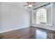 Bright bedroom featuring a large window, hardwood floors, and neutral wall color at 13008 Ginovanni Way, Mint Hill, NC 28227