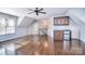 Bonus room with hardwood floors, wet bar, mini fridge and staircase at 13008 Ginovanni Way, Mint Hill, NC 28227