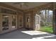 Covered patio with stone arches, ceiling fan, and a view of the landscaped backyard at 13008 Ginovanni Way, Mint Hill, NC 28227
