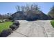 Attractive home exterior features a long driveway, mature landscaping, and a two-car garage at 13008 Ginovanni Way, Mint Hill, NC 28227