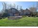 Beautiful stone and brick home featuring a manicured lawn and mature landscaping for great curb appeal at 13008 Ginovanni Way, Mint Hill, NC 28227