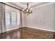 Bright living room with hardwood floors, plantation shutters, and elegant chandelier lighting at 13008 Ginovanni Way, Mint Hill, NC 28227