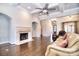 Bright living room features a stone fireplace, hardwood floors, and coffered ceilings with an open concept design at 13008 Ginovanni Way, Mint Hill, NC 28227