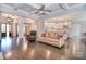 Open-concept living space with hardwood floors seamlessly connects the living room to kitchen with stainless steel appliances at 13008 Ginovanni Way, Mint Hill, NC 28227