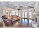 Open-concept living area with stone fireplace, hardwood floors, and access to outdoor living space at 13008 Ginovanni Way, Mint Hill, NC 28227