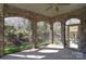 Covered patio with stone arches, ceiling fan, and a view of the landscaped backyard at 13008 Ginovanni Way, Mint Hill, NC 28227