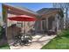 Lovely patio with outdoor seating, red umbrella, and screened-in porch, perfect for relaxation at 13008 Ginovanni Way, Mint Hill, NC 28227