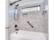 Shower over tub featuring decorative tile, bronze fixtures, a shower head and a decorative window at 13008 Ginovanni Way, Mint Hill, NC 28227