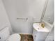 Compact half bathroom featuring a modern sink, gold fixtures, and a tiled floor at 1442 Rainforest Ct, Gastonia, NC 28054