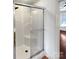 Shower stall with glass doors and built-in seat, complemented by neutral tiling and fixtures at 1442 Rainforest Ct, Gastonia, NC 28054