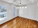 Bright dining room featuring hardwood floors, neutral walls, modern lighting, and natural light from large windows at 1442 Rainforest Ct, Gastonia, NC 28054