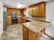 Classic kitchen features granite counters, stainless steel appliances, tile floor, and lots of storage at 1442 Rainforest Ct, Gastonia, NC 28054