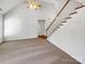 Bright, open-concept living area with stairs, neutral carpet, and a view of the home's layout at 1442 Rainforest Ct, Gastonia, NC 28054