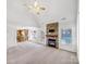 Open living room with a stone fireplace, ceiling fan, and access to the kitchen and outdoor space at 1442 Rainforest Ct, Gastonia, NC 28054