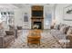Bright living room features a stone fireplace, hardwood mantle, modern decor and ample seating at 1442 Rainforest Ct, Gastonia, NC 28054