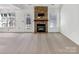 Open-concept living room features a stone fireplace, and a door to outdoor entertaining at 1442 Rainforest Ct, Gastonia, NC 28054