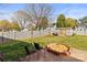 Backyard features seating, a sandbox, privacy fence, and a large grassy area at 1448 Morrocroft Trl, Gastonia, NC 28054