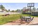 Backyard area features an outdoor table set, play set, and plenty of green space at 1448 Morrocroft Trl, Gastonia, NC 28054