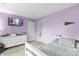 Stylish bedroom with lavender walls, a modern dresser, and a television, offering a cozy retreat at 1448 Morrocroft Trl, Gastonia, NC 28054