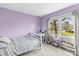 Charming bedroom featuring a cozy bed, natural light from a large window, and a vanity area at 1448 Morrocroft Trl, Gastonia, NC 28054