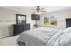 Cozy bedroom with a large window, ceiling fan, and dresser; a relaxing retreat at 1448 Morrocroft Trl, Gastonia, NC 28054