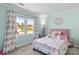 Bright bedroom with owl-themed decor, a cozy bed, and plenty of natural light from a large window at 1448 Morrocroft Trl, Gastonia, NC 28054