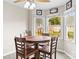 Bright eat-in kitchen features a wooden table, chairs, and lots of windows overlooking the backyard at 1448 Morrocroft Trl, Gastonia, NC 28054