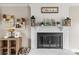 Inviting living room showcasing a decorative white brick fireplace and stylish mantle decor at 1448 Morrocroft Trl, Gastonia, NC 28054