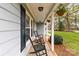 Charming front porch with rocking chairs and hanging flower baskets at 1448 Morrocroft Trl, Gastonia, NC 28054