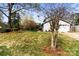 Well-maintained front yard with mature trees, lawn, and landscaping leading to the home's entrance at 1448 Morrocroft Trl, Gastonia, NC 28054