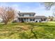 Charming two-story home with a well-maintained lawn, beautiful tree, and inviting front porch at 1448 Morrocroft Trl, Gastonia, NC 28054