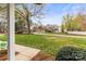 Corner lot neighborhood street with lush trees and well-maintained lawns at 1448 Morrocroft Trl, Gastonia, NC 28054