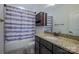 Bathroom featuring a combination tub and shower, a granite countertop and decorative elements; functional and stylish at 15125 Skypark Dr, Huntersville, NC 28078