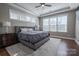 Serene main bedroom with tray ceilings, large windows, and plush bedding for ultimate relaxation at 15125 Skypark Dr, Huntersville, NC 28078