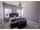Bright bedroom with two windows, carpeted floor, stylish black decor, and plenty of light at 15125 Skypark Dr, Huntersville, NC 28078