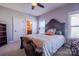Cozy bedroom featuring a bed, chair, carpeted floor, and natural light from the window at 15125 Skypark Dr, Huntersville, NC 28078