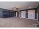 Spacious bonus room features a carpeted floor, ceiling fan, built in shelves, three doors, and ample closet space at 15125 Skypark Dr, Huntersville, NC 28078