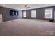 Large bonus room with neutral carpet, three windows and a ceiling fan for maximum comfort and usability at 15125 Skypark Dr, Huntersville, NC 28078