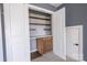 Walk-in closet with built-in shelves, a desk area, and natural light at 15125 Skypark Dr, Huntersville, NC 28078