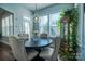 Bright dining area features a round table, modern light fixture, and large windows with natural light at 15125 Skypark Dr, Huntersville, NC 28078