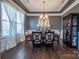 Inviting dining area with a decorative chandelier, dark wood table and hardwood flooring at 15125 Skypark Dr, Huntersville, NC 28078