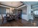 Elegant dining room boasts tray ceilings, modern chandelier, and hardwood floors at 15125 Skypark Dr, Huntersville, NC 28078